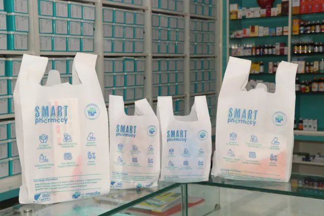 Pharmacy bags are lined up on the counter, ready for the next step. — Ramnagri Store