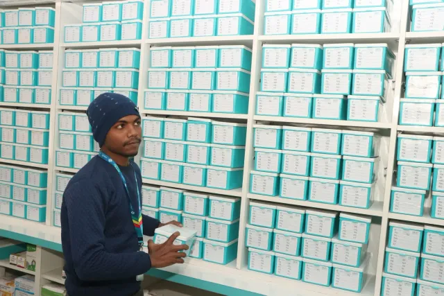 The pharmacy team works among neatly arranged storage drawers. — Ramnagri Store