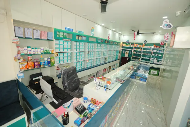 A view across the bright pharmacy counter and display shelves. — Bhurbhura More, Deoghar