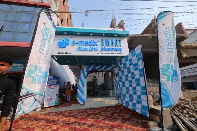 Branded flags and a decorated entrance welcome opening-day visitors. — Patepur road, Mahua
