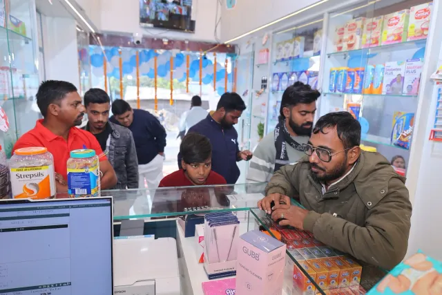 A candid look at the team working around the counter. — Patepur road, Mahua