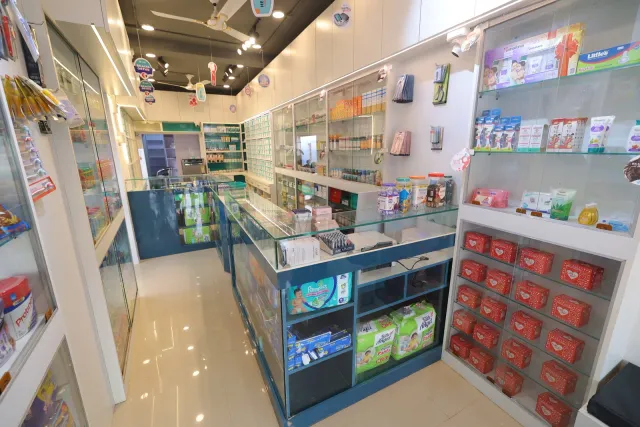 A clear view down the pharmacy's bright central aisle. — Patepur road, Mahua