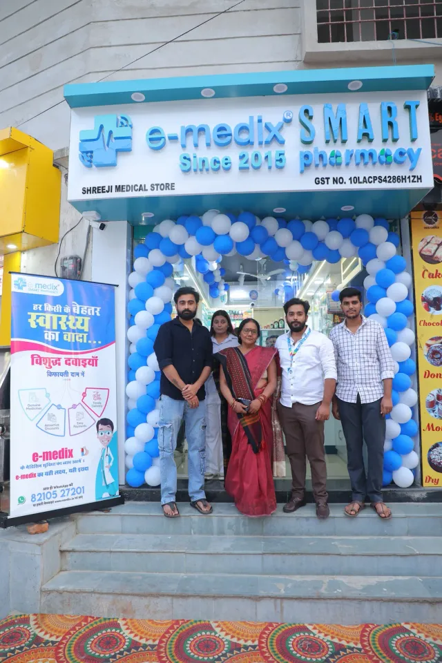 A group photograph brings guests together outside the pharmacy. — Buddha Colony