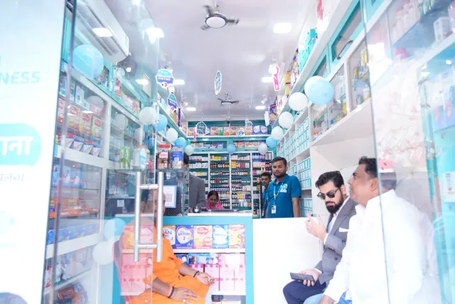 A bright aisle offers a view into the pharmacy's glass-fronted displays. — Raxaul