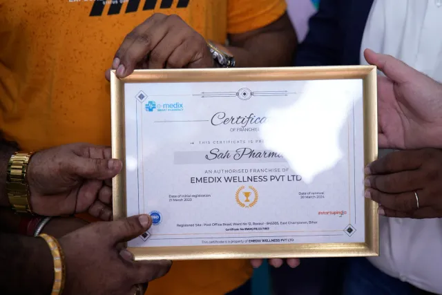 A close-up of the store's framed franchise certificate. — Raxaul