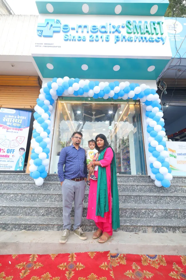 Guests pause together outside the balloon-framed entrance. — Usri Bazar